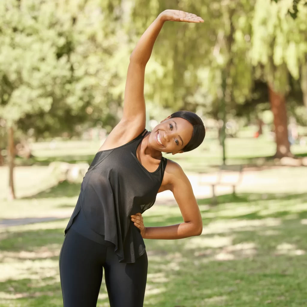 black woman stretching or fitness in nature park utc