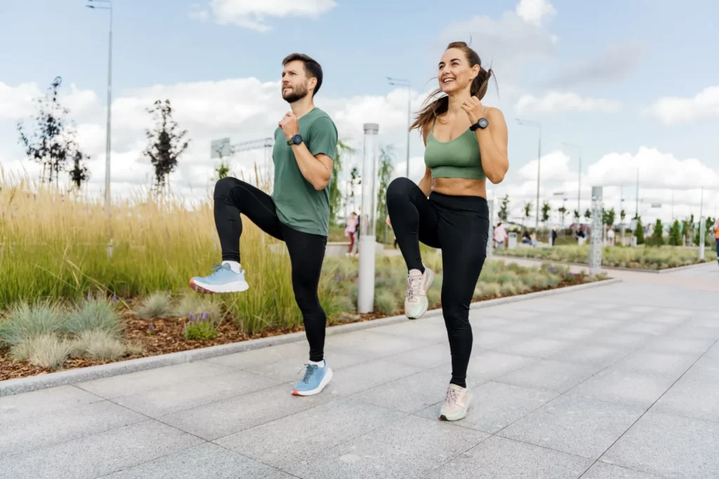 couple working out together on paved path utc